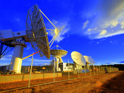 Twilight image of nbn ground station at Wolumla, with satellite dishes pointed at the sky