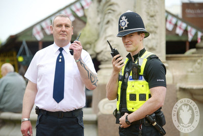 Police officers holding radios