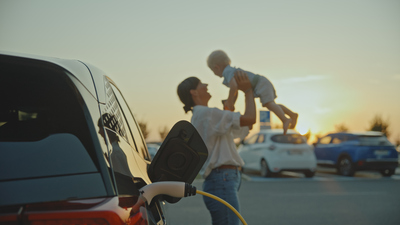 woman and baby with electric vehicle charging